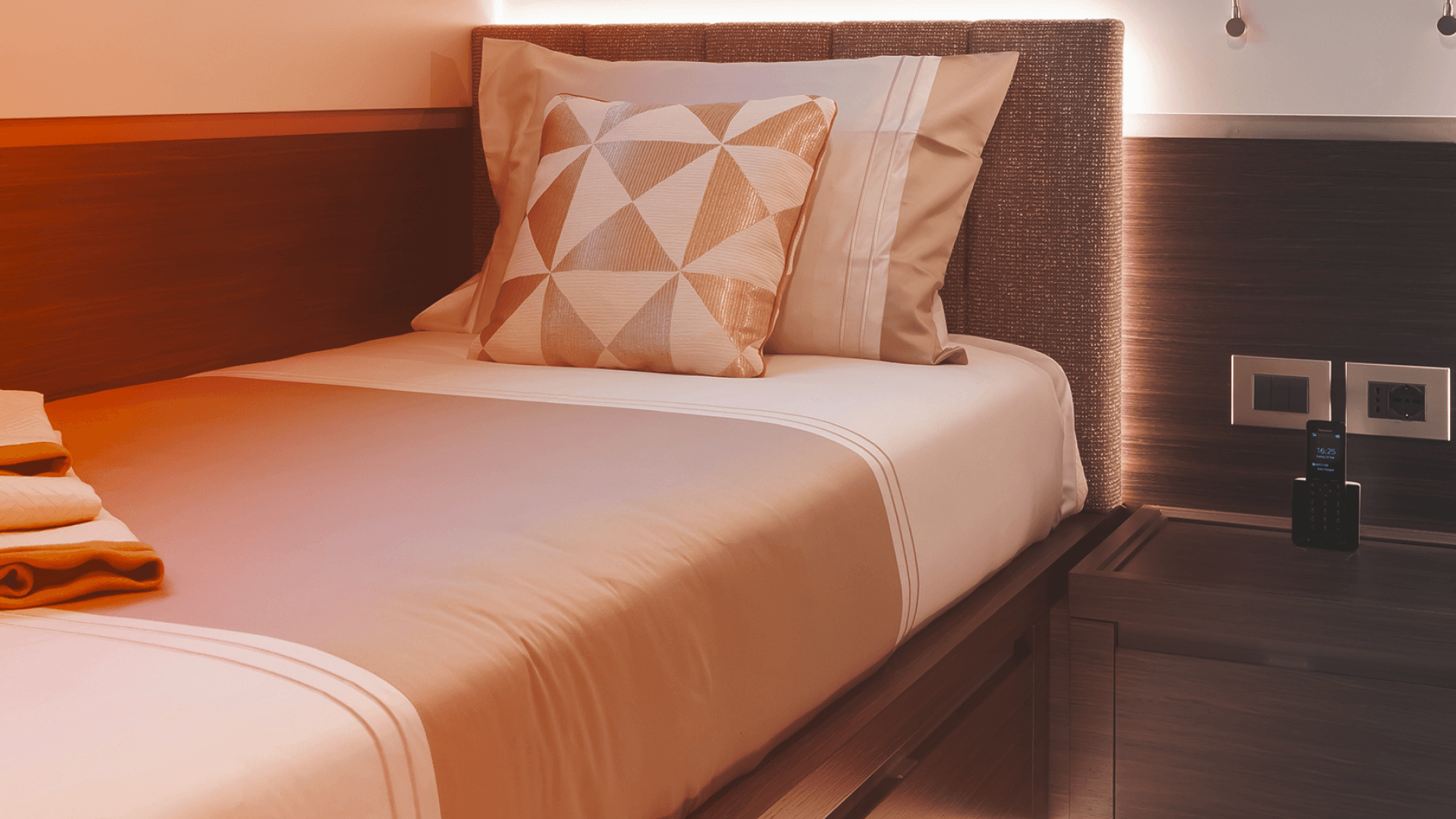 Single-bed offshore room with personal workspace, and desk, for modern worker accommodation.